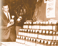 Argia B at tradeshow in 1960s presenting his famous MUMBO SAUCE